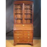 A George III mahogany bureau bookcase with pediment and gothic arched glazed doors, the fall front