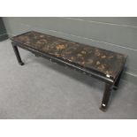 A black chinoiserie and ebonised coffee table, 46 x 148 x 39cm