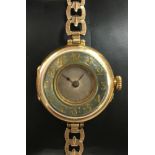 Rolex - A lady's 18ct gold wristwatch, the circular unsigned silvered dial with green/grey enamel