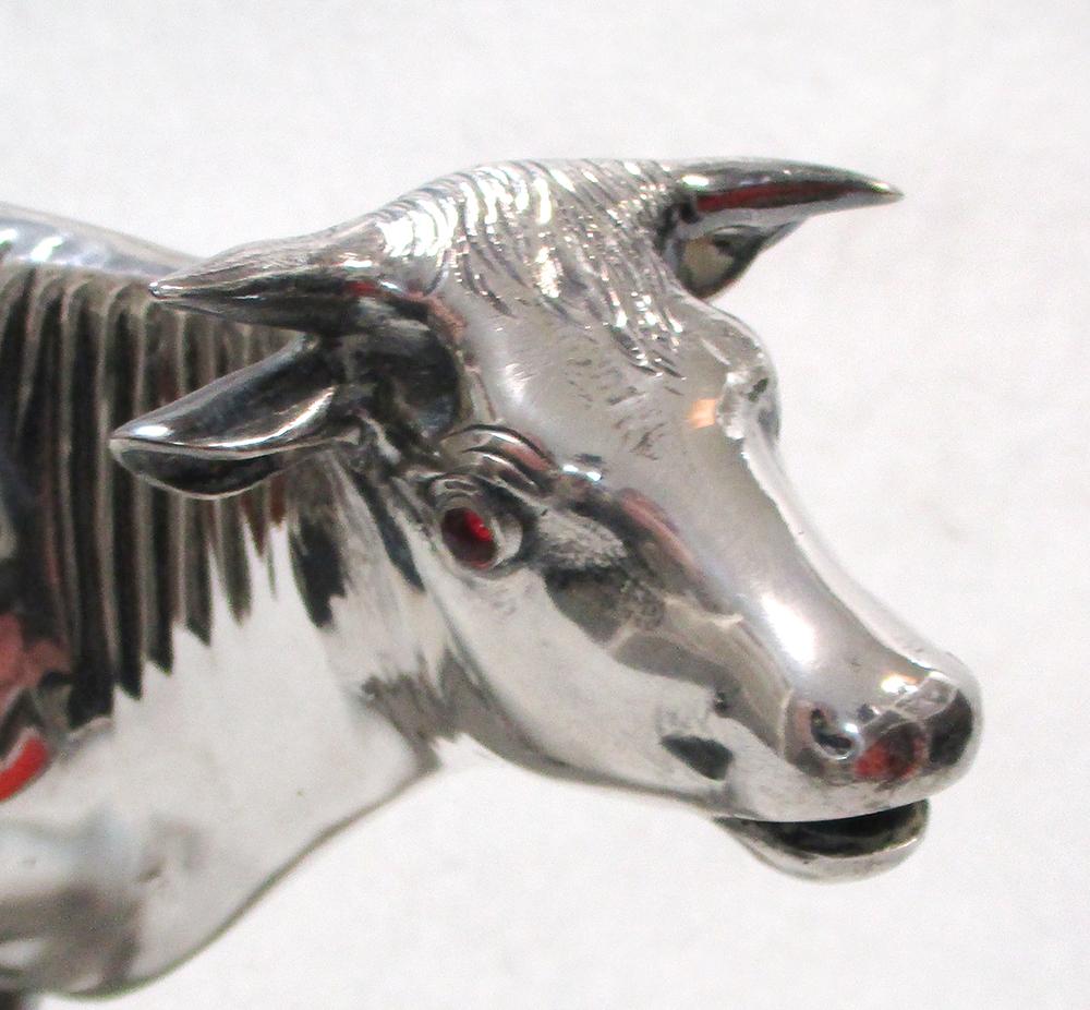 A German oversized cow creamer, of plain form with hinged saddle heavily decorated with engraving - Image 2 of 3