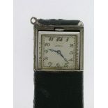 Vertex - a silver and leather sprung loaded purse watch, the square signed cream coloured dial