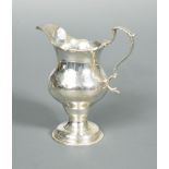 A George III silver cream jug by Hester Bateman, London 1775, pyriform below a cut edge, with flying