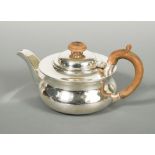 A George V silver bachelor teapot, by Holland, Aldwinckle & Slater, London 1913, of squat circular