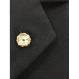 An unsigned continental novelty lapel watch, the circular cream dial with black Roman numerals,