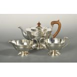 An Art Nouveau style silver three piece tea set, by Pearce & Sons, London 1920, the teapot of