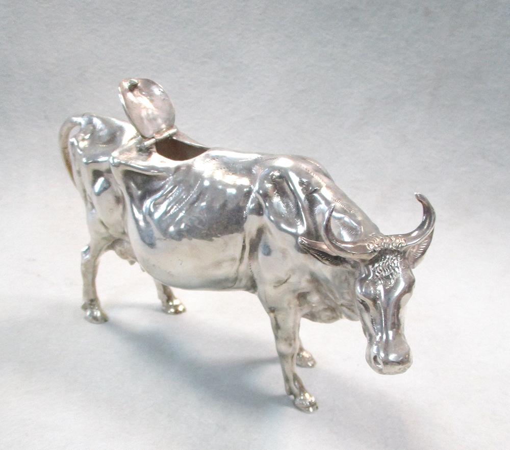 A continental naturalistic cow creamer, the detailed cast body with hinged saddle decorated with a - Image 4 of 6