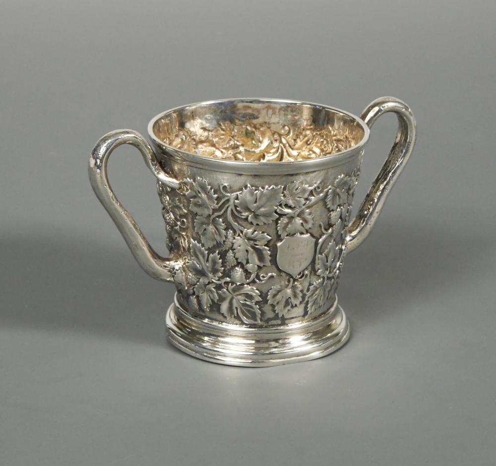 A Victorian silver two handled mug by John Samuel Hunt, London 1863, heavily embossed all over