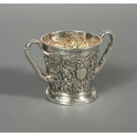 A Victorian silver two handled mug by John Samuel Hunt, London 1863, heavily embossed all over