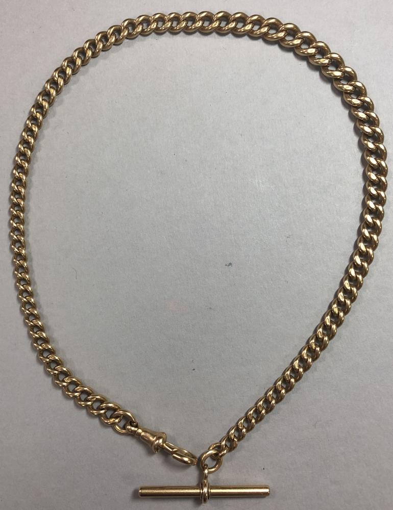 A graduated curb link watch chain, with T bar and one swivel catch, part marked for 18ct gold on