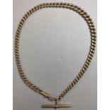 A graduated curb link watch chain, with T bar and one swivel catch, part marked for 18ct gold on