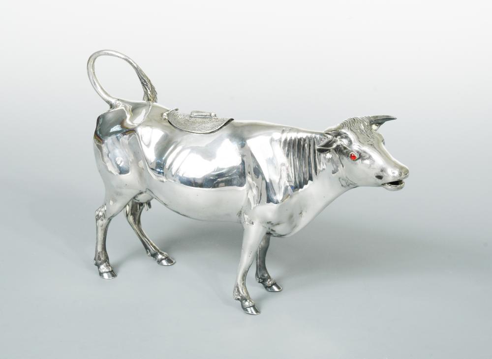 A German oversized cow creamer, of plain form with hinged saddle heavily decorated with engraving
