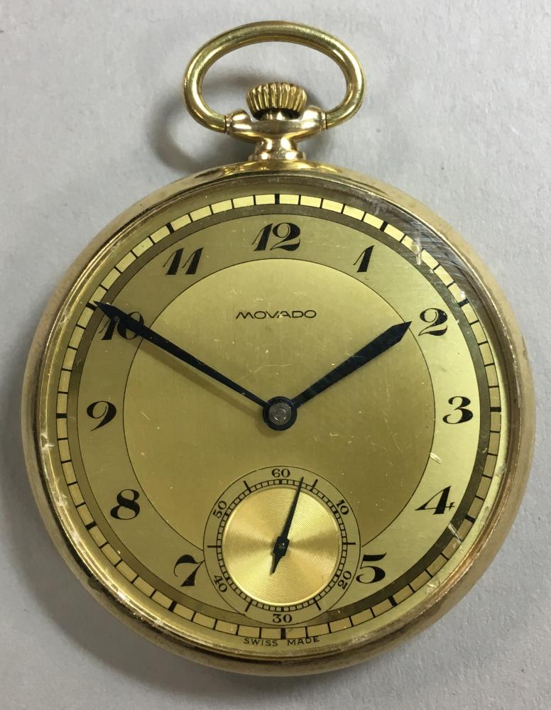 Movado - an open faced dress pocket watch, the signed champagne dial with black Arabic numerals,