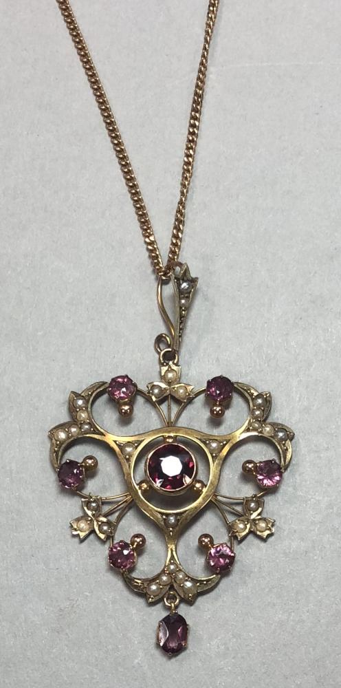 An Edwardian garnet and seed pearl pendant with later chain, the ...