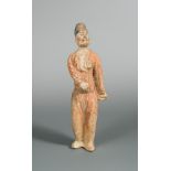 A Tang dynasty terracotta man servant, with traces of polychrome decoration, 31cm high Wear and