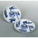 Three 19th century dishes, two similarly painted with an elephant, Qilin and leopard encircling a