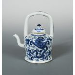 An early 19th century tea pot and cover, the handle raised above two dragons, the cover painted with