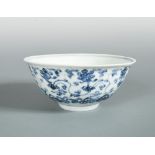 A Ming dynasty early 15th century bowl, painted with lotus scrolling in a band on the exterior above