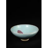 A large Junyao bowl, Yuan dynasty, covered overall with a milky lavender glaze, with a reddish