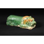 A sancai-glazed lion-form pottery pillow, Liao dynasty, the lion modelled in a recumbent position