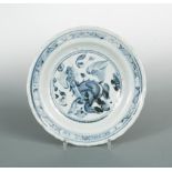 A 15th century Ming dynasty dish, painted with a Qilin roundel, the reverse cavetto moulding with