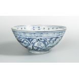A Ming dynasty bowl, painted with a flowering vine scrolling around the rosette central to the