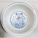 A pair of blue and white provincial Ming bowls, the exteriors painted with flowers above flame-