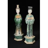 A pair of Ming dynasty attendants with removable heads, each standing on a hexagonal plinth, the