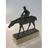 A bronzed spelter figure of a racehorse with jockey up, circa 1920, on marble base, 24cm high