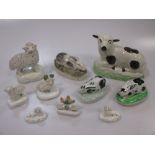 A group of pottery rabbit, sheep and dog figures, 19th century, comprising seated ewe (