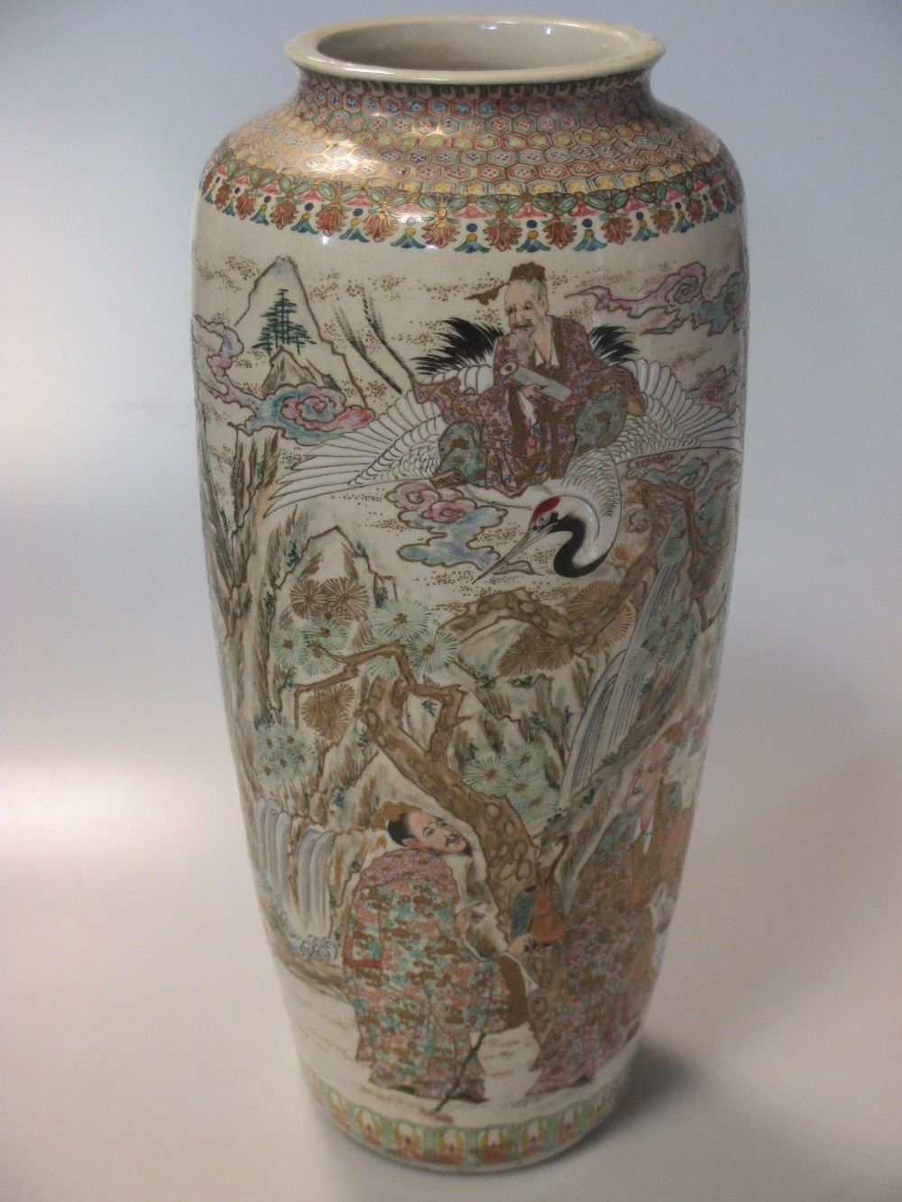 A Japanese earthenware vase, Meiji, circa 1900, decorated with immortals in a rocky landscape,