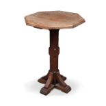 A mahogany Gothic revival lamp table, the octagonal top on similarly shaped knopped column and