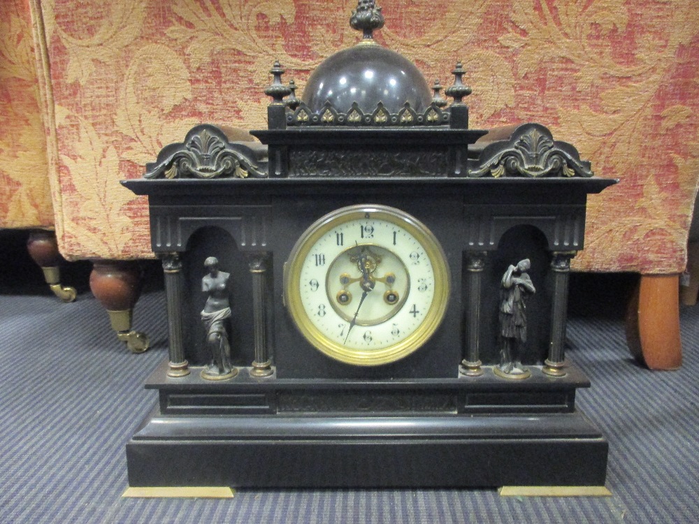 A late 19th French black marble mantle clock with visible escapement 40cm wide