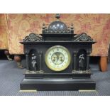 A late 19th French black marble mantle clock with visible escapement 40cm wide