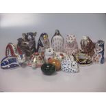 A collection of 12 Royal Crown Derby imari birds and animals, including a dragon, koala bear, walrus