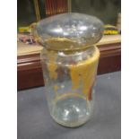 A large 19th century glass chemist jar and cover with remnants of gilt decoration and a coat of arms