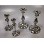 A pair of early 20th century silver candlesticks and two other candlesticks (4)