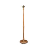 An early twentieth century pale oak standard lamp, with original triple bulb holder, fluted and
