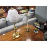 Two brass Edwardian table lamps with glass shades; an American brass reading lamp and a brass