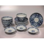 A set of four Japanese blue and white tea bowls and saucers each decorated with floral panels and