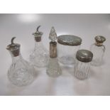Three Victorian silver topped cut glass dressing table jars, a cut glass perfume bottle with