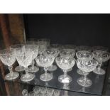 An extensive Edwardian cut glass suite of glass engraved with a monogram to include, champagne