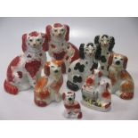 Three pairs of Victorian Staffordshire pottery seated spaniels, the largest 16cm high; and two other