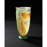 A Roman iridescent glass beaker, 1st century AD, the tapering cylindrical body with flared rim and