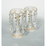 A near pair of Victorian frosted glass table lustres each with barbed overhanging gilt rims, the