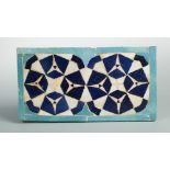 An Islamic Persian rectangular mosaic tile, with a geometric design in tones of blue and turquoise