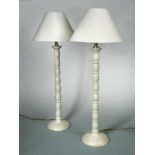 A pair of table lamps by Porta Romana, in 'old stone' scumbled finish and matching linen shades,