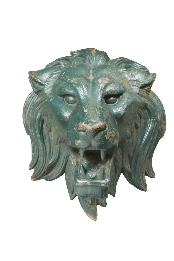 A large 19th century cast iron lion mask door mount, the green painted mask mounted to a rod, a