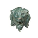 A large 19th century cast iron lion mask door mount, the green painted mask mounted to a rod, a
