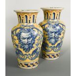 A pair of large 19th century yellow ground Talavera vases, the shouldered ovoid bodies boldly