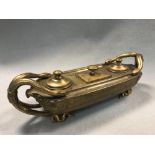 A 19th century gilt metal ink stand, the boat form with twin serpent handles to either side, the top